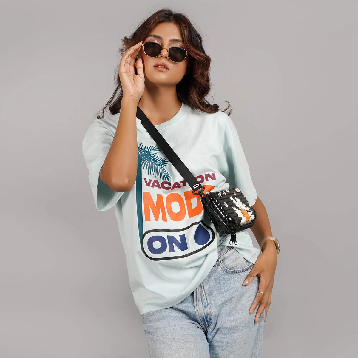 Buy Aqua blue oversized T-shirt for women with 'Vacation Mode On' graphic print. Features drop shoulders, round collar, and cotton fabric