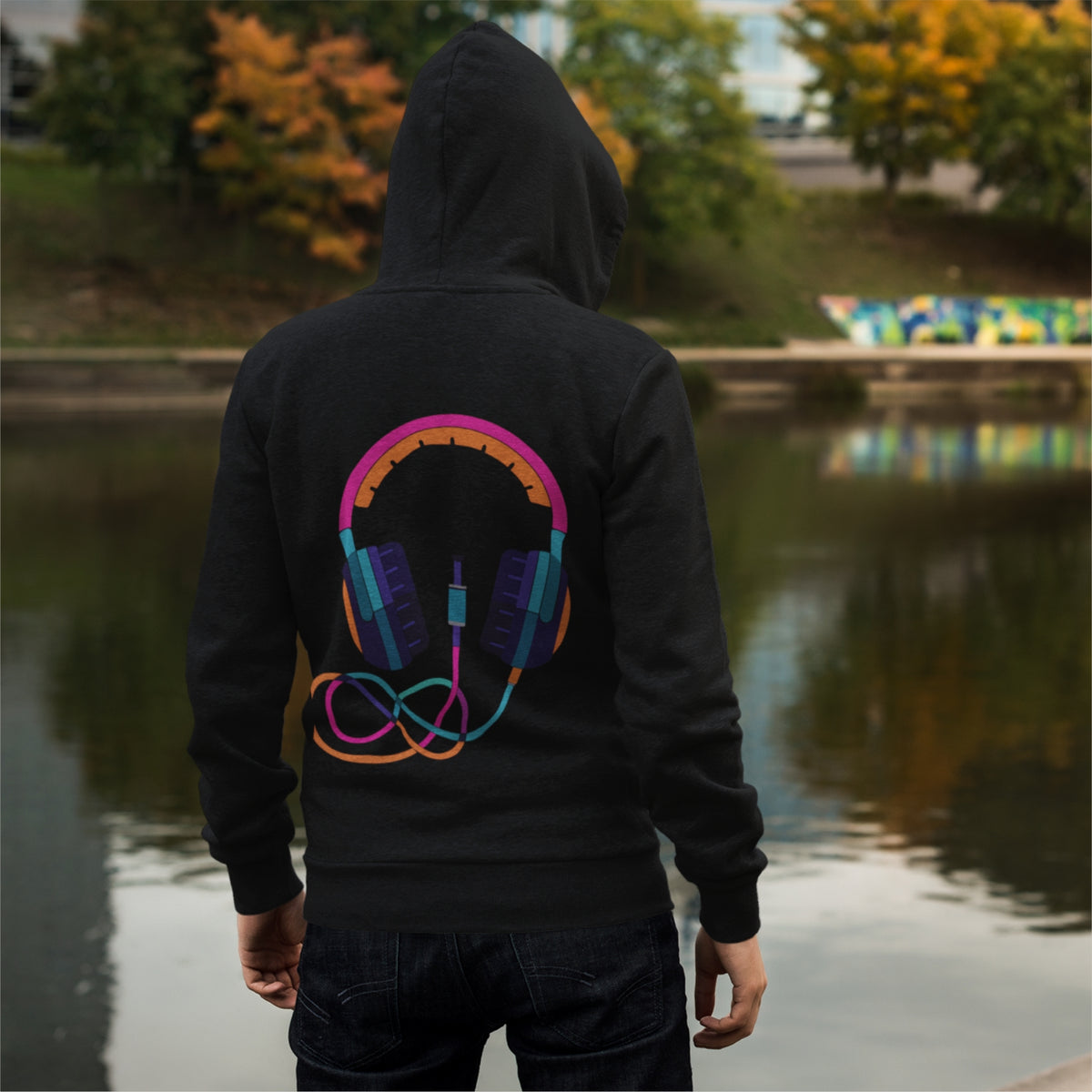 Get the headphone graphic print oversized hoodie in black, perfect for casual wear with cuffed sleeves and a hood.