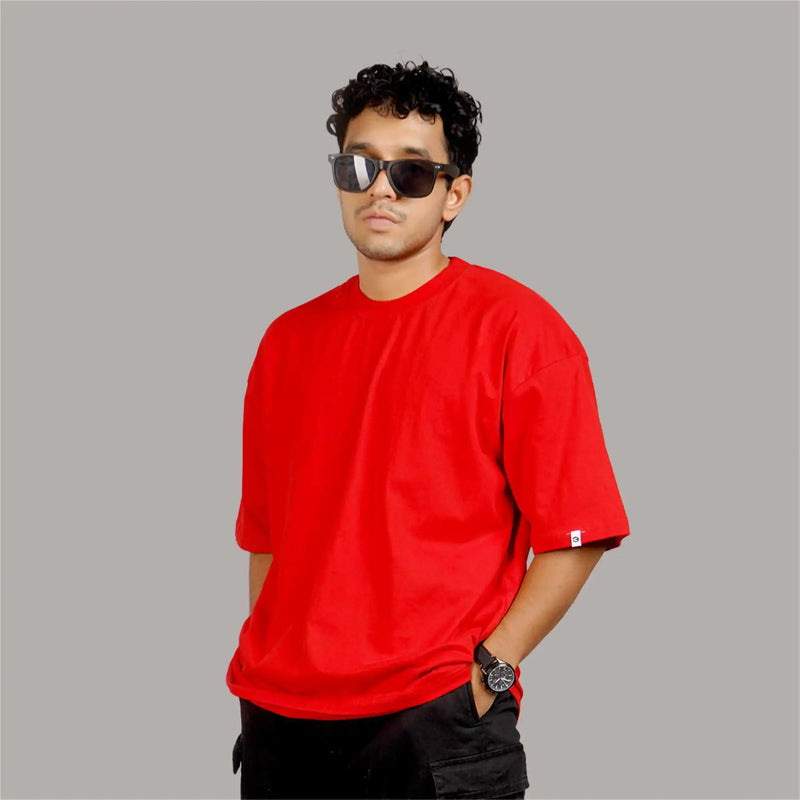 Red color oversized T-shirt for men, featuring a drop shoulder design, round collar, and made from soft 100% cotton.