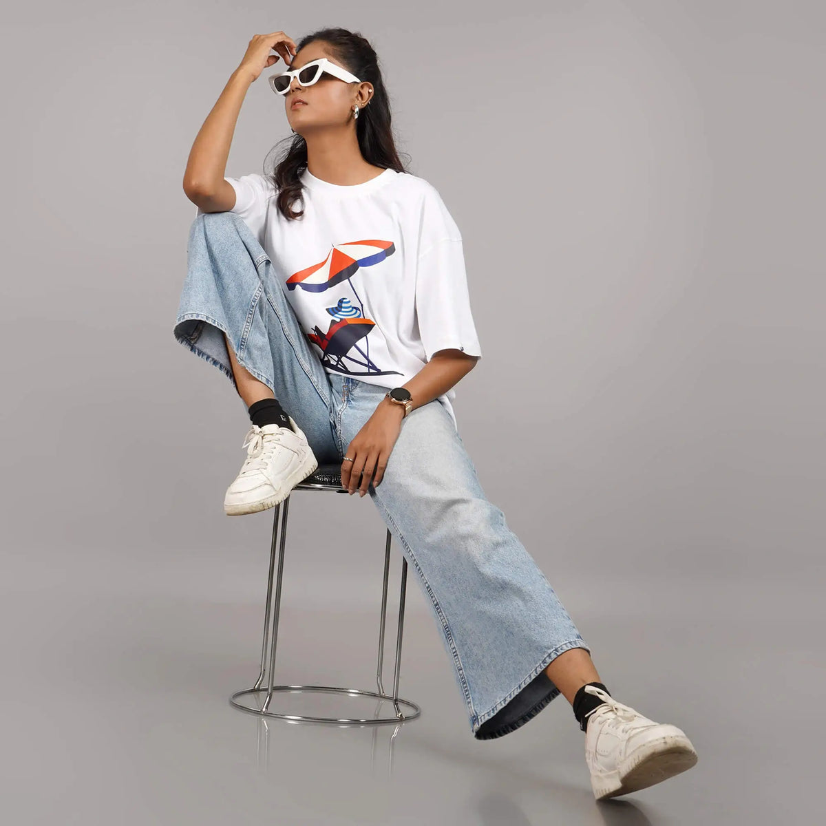 White oversized T-shirt for women featuring 'Sun Beach' print, round neck, and drop shoulders. Soft cotton. Shop online now.