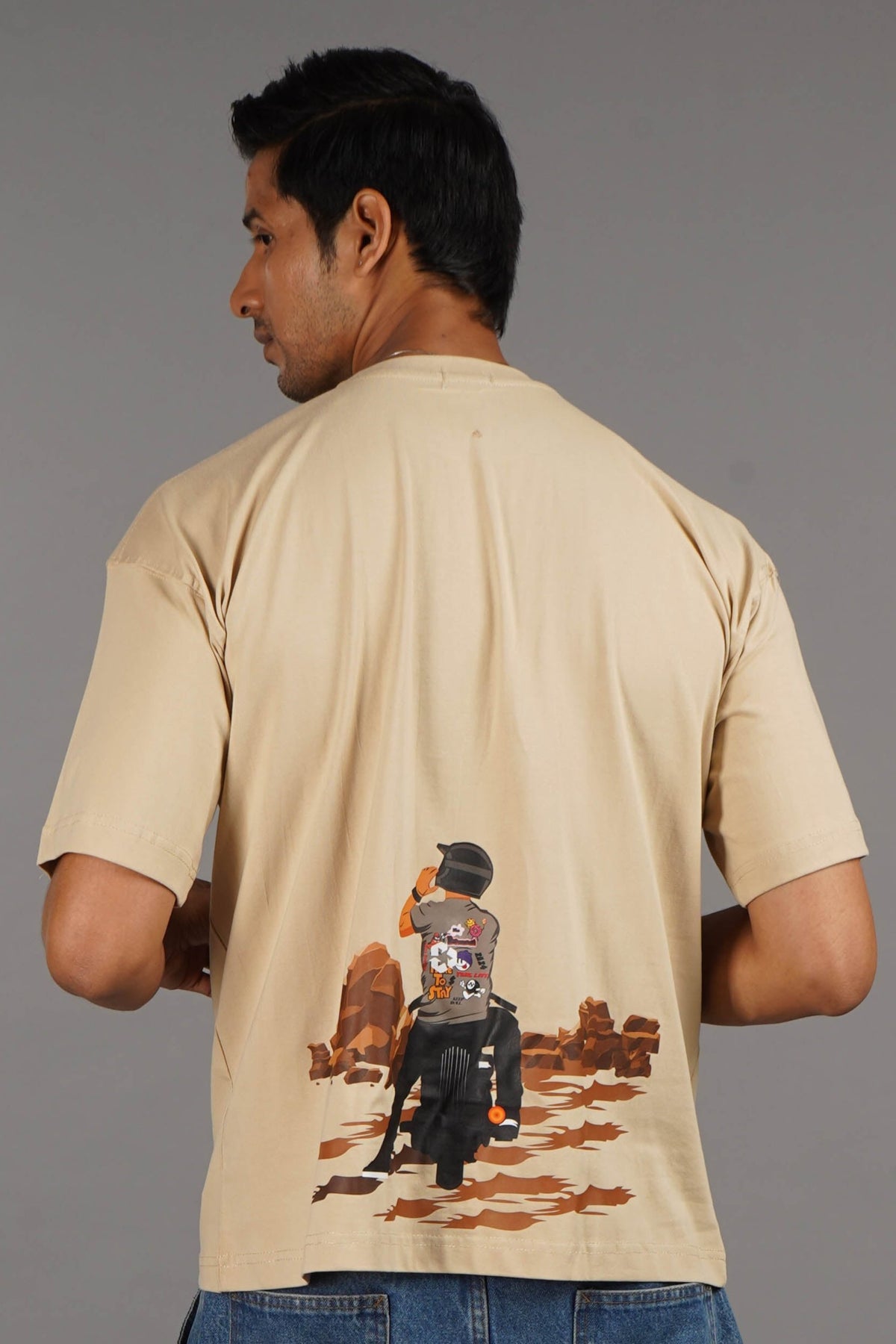 Get the beige Biker Oversized T-Shirt, a unisex essential with a comfortable, loose fit. Ideal for a casual, effortless look.