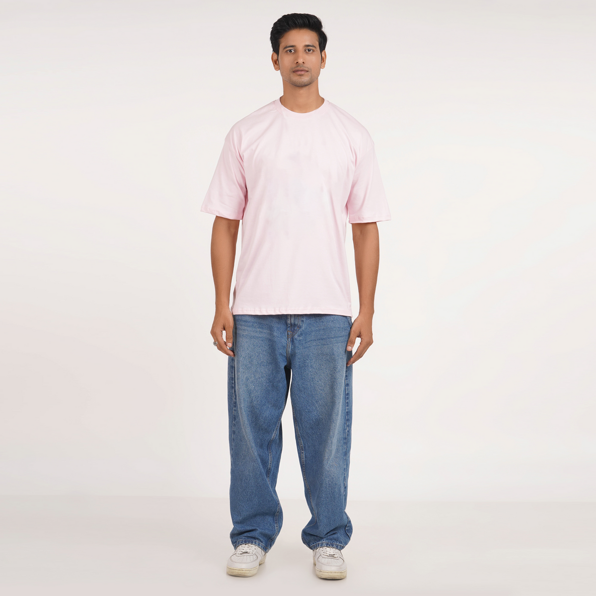 Men's pink oversized T-shirt with drop shoulder, graphic print, and 100% cotton. Perfect blend of comfort and fashion.
