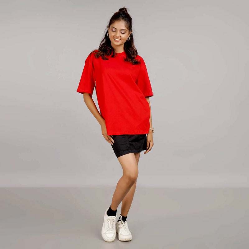 Purchase a casual red oversized T-shirt for ladies that is made of soft, breathable cotton and has a round collar and drop shoulder design.