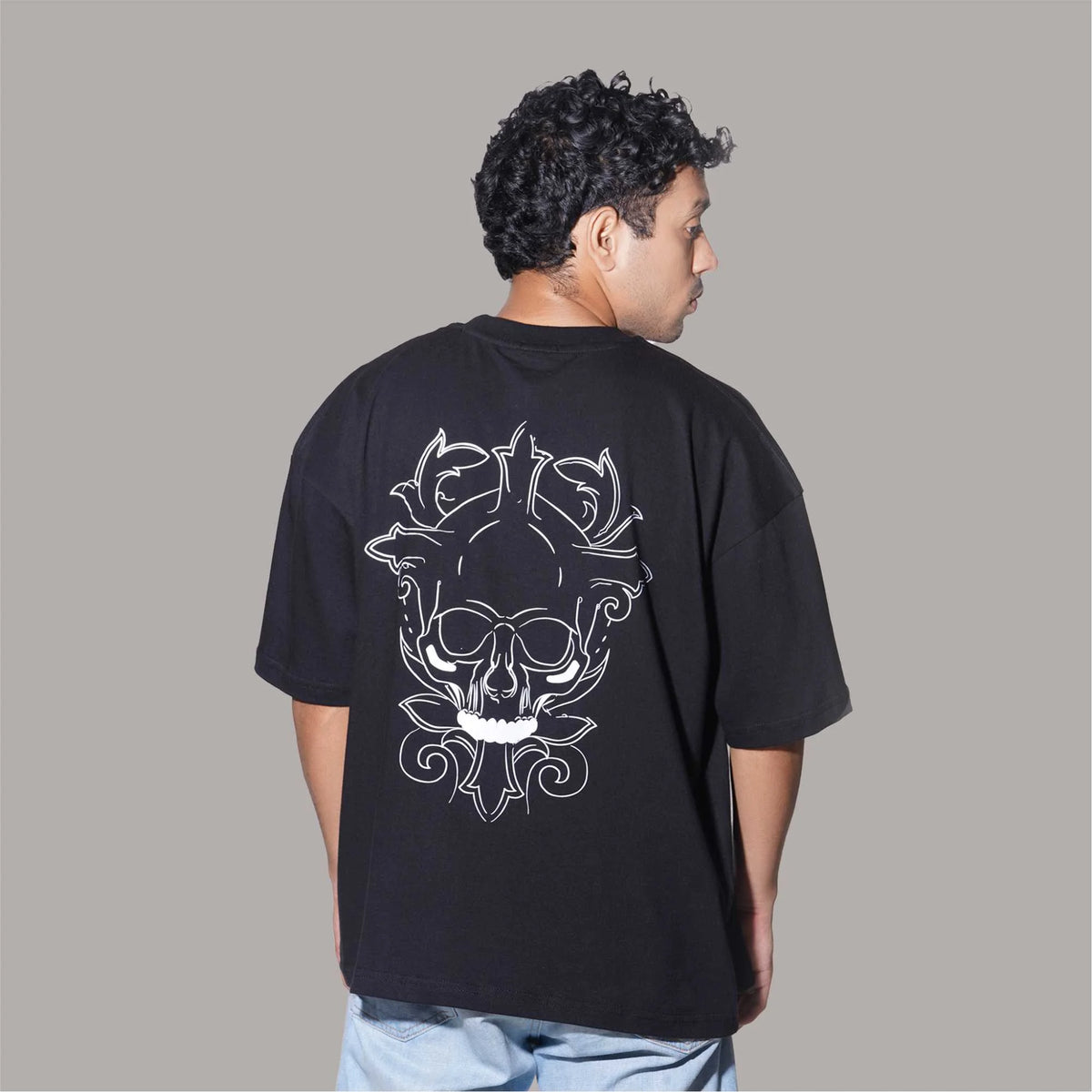 Buy Reflective Skull : Black oversized T-shirt with a reflective skull print, drop shoulders, and a round collar, made of cotton