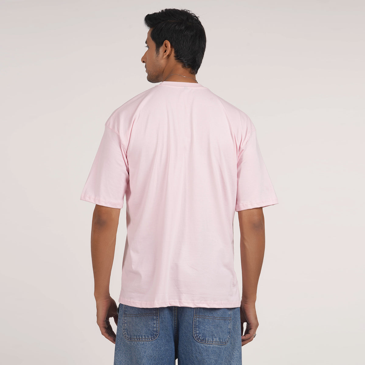 Shop men's oversized T-shirt in pink with drop shoulder and graphic print, made from 100% cotton for ultimate comfort.
