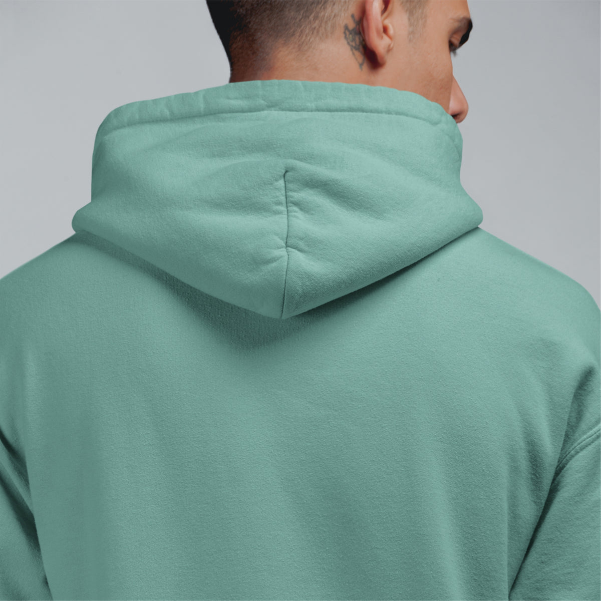 Stylish oversized hoodie men in Turtle Green. Perfect for couples, this essential sweatshirt for men adds a trendy touch to your wardrobe.