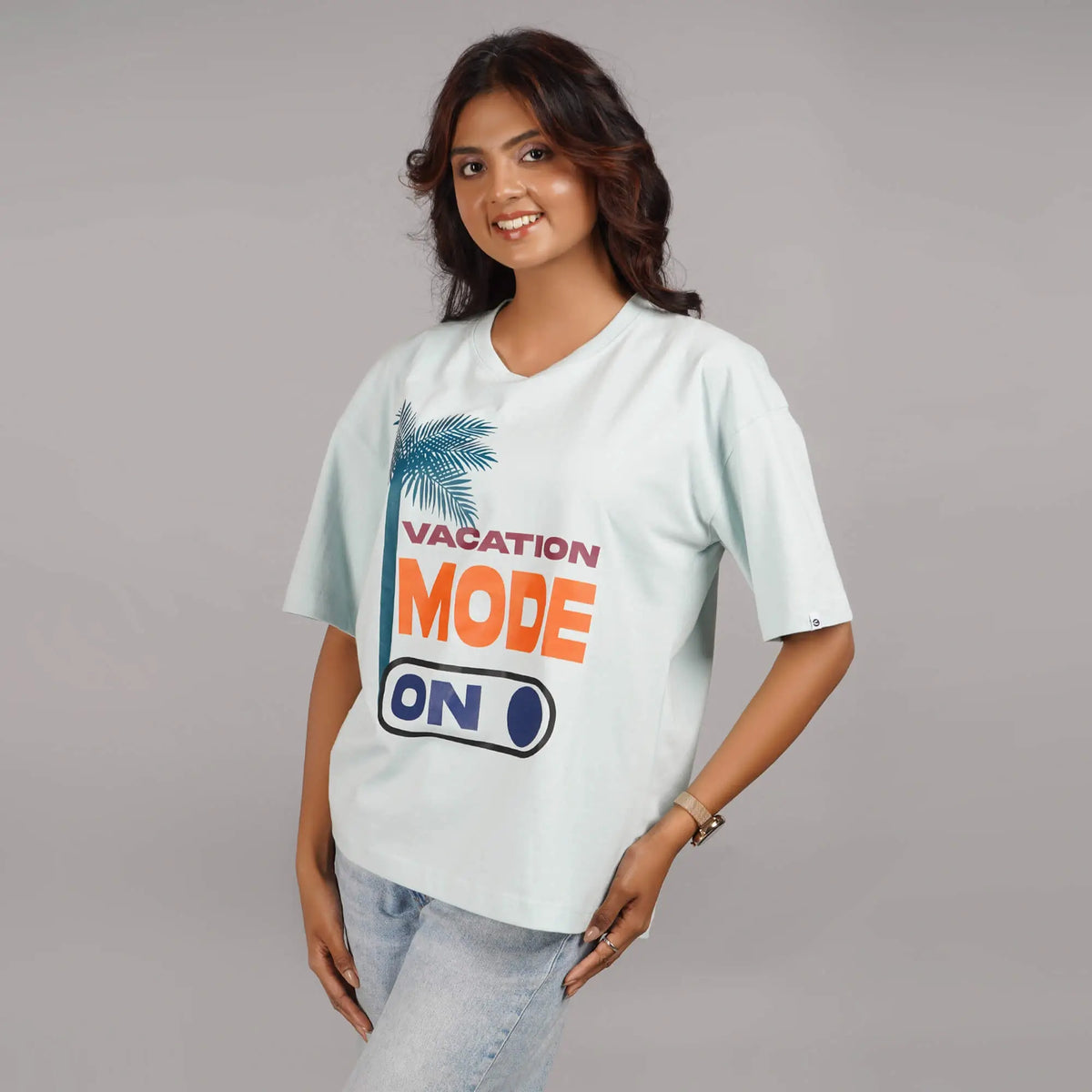 Vacation Mode On graphic on a contemporary aqua blue oversized T-shirt for women. Soft cotton, drop shoulder, and round collar design