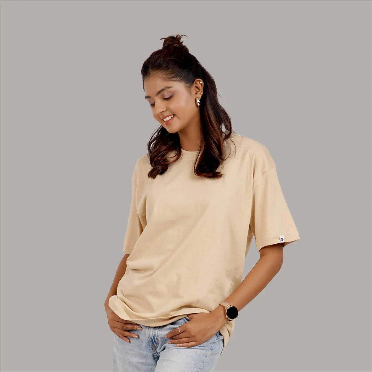 Beige oversized T-shirt for women, drop shoulder design, round collar, 100% soft cotton for all-day comfort.