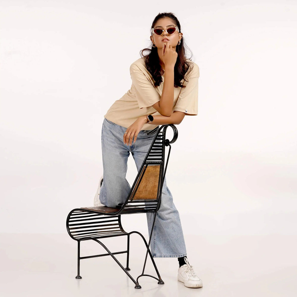 Women's beige oversized T-shirt with drop shoulder design, round collar, and soft 100% cotton fabric.