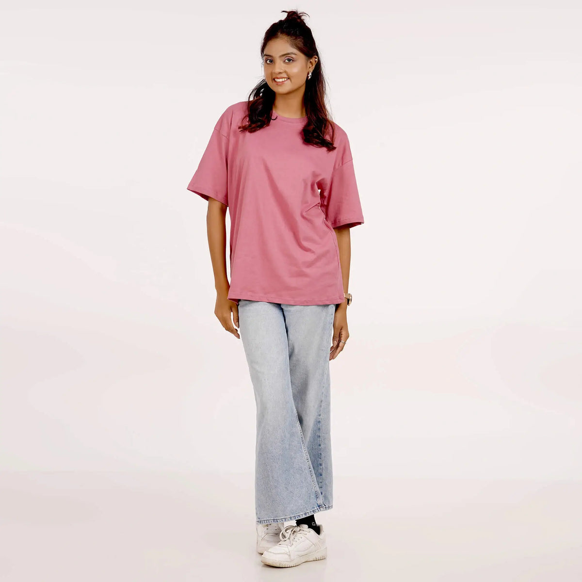 pink oversized T-shirt for women with drop shoulders and round collar. Made from soft cotton. Shop online for a casual style